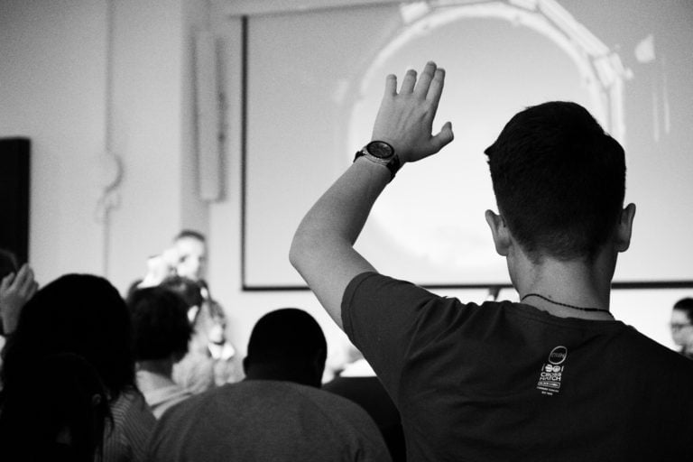 student raising his hand