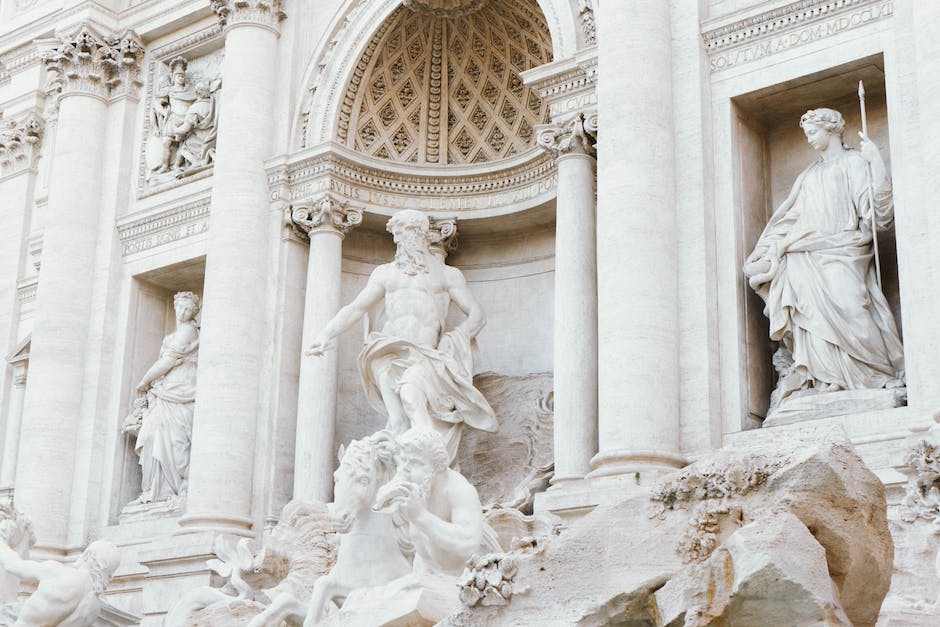 Ancient Greek statues surrounded by cloudy background, symbolizing the enduring influence of Greek mythology and its impact on art and culture.